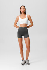 Fitness woman. Athletic girl on the gray background