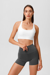 Fitness woman. Athletic girl on the gray background