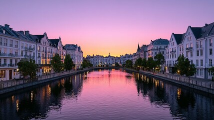 Obraz premium A tranquil canal scene at dusk with buildings lining the water's edge.