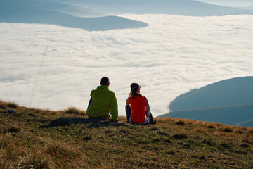 Fototapeta premium Couple in Love Enjoying the View at the Top of a Mountain.