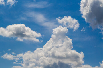 White fluffy clouds in a blue sky, a view among the clouds high in the sky, beautiful white clouds...