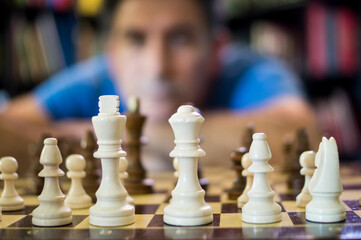 person attentive to the chess game
