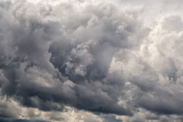Waves of gray clouds resembling large ocean waves, gray clouds close-up, approaching storm and...