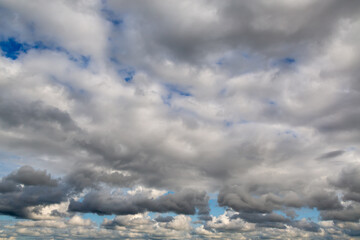 The sky is filled with white clouds in a blue sky to the horizon, a heavenly landscape with clouds...