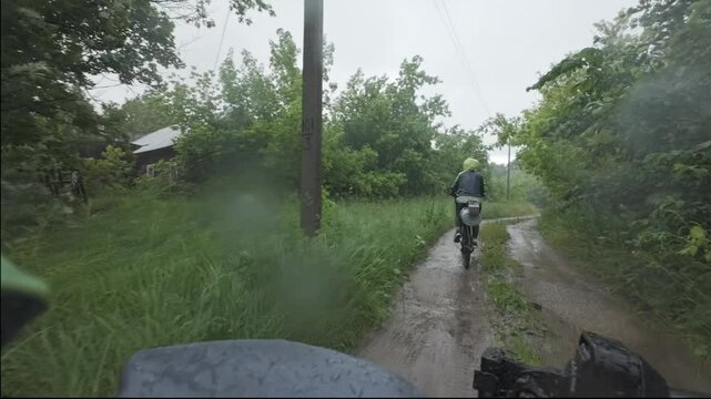 cycling in nature in wild places, bike-packing. Riding in the forest in the rain