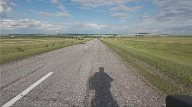 cycling in nature in wild places, bike parking.A couple rides a bike on asphalt