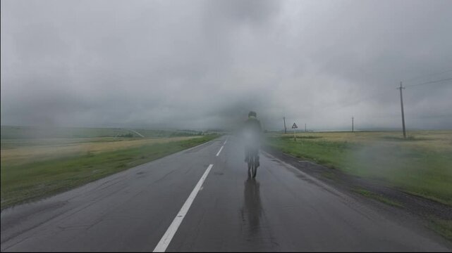 cycling in nature in wild places, bike-packing. Driving in cloudy weather in the rain