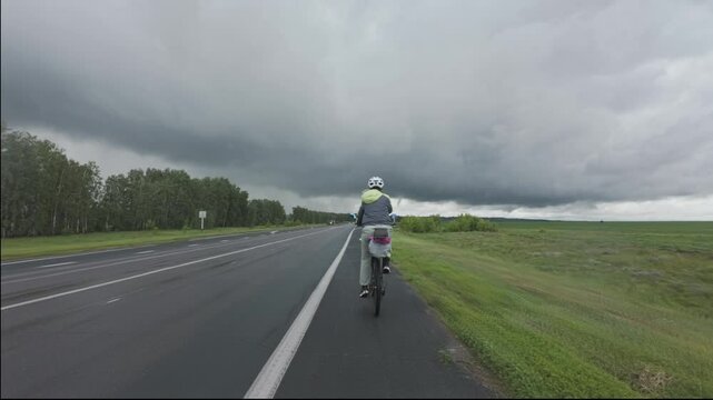 cycling in nature in wild places, bike-packing. Driving in cloudy weather in the rain