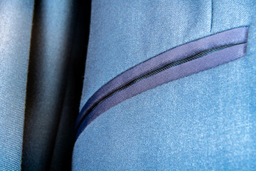 Close-up of suit jacket pocket seam with contrast fabric and tailored stitching details, fashion and textile industry concept