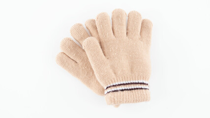 Warm gloves resting on a white surface