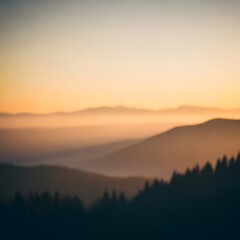 Blurred mountains and forest at sunset create a dreamy landscape scene.