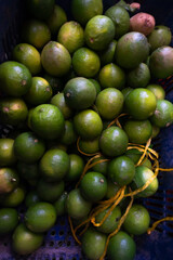 Green lemons on display for sale at a traditional Brazilian fair. Healthy food.