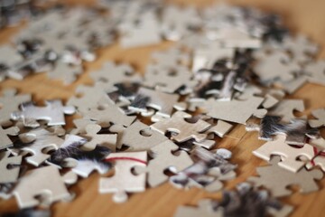 Jigsaw puzzle pieces on the table closeup photo 