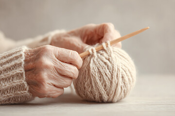 Warm Nostalgic Moment of Hands Knitting on Neutral Background