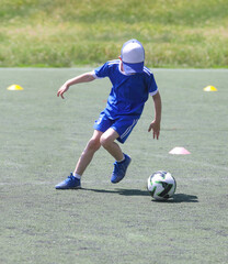  teen  boy plays football at a sports school .