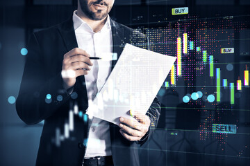 Businessman analyzing stock market data with financial charts and trading graphs in futuristic digital interface background.