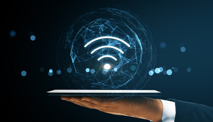 Wireless network symbol above digital tablet held by hand with futuristic tech connecting lines on...
