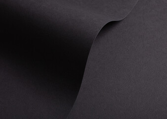 Chic, modern designer paper texture with dark, monochrome backdrop. Elegant, minimalistic sheet with