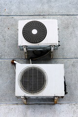 Two Old Air Conditioners Mounted on an Exterior Wall, Showcasing Urban Decay and Vintage Design.
