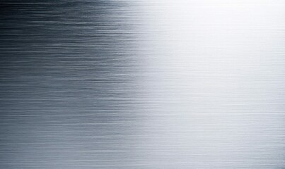 This is a close-up of a brushed metal texture, with a gradient of light and shadow across the surface.