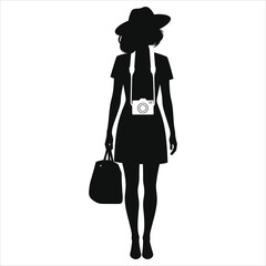 A stylish woman in a dress and hat carries a camera and bag, isolated on white background