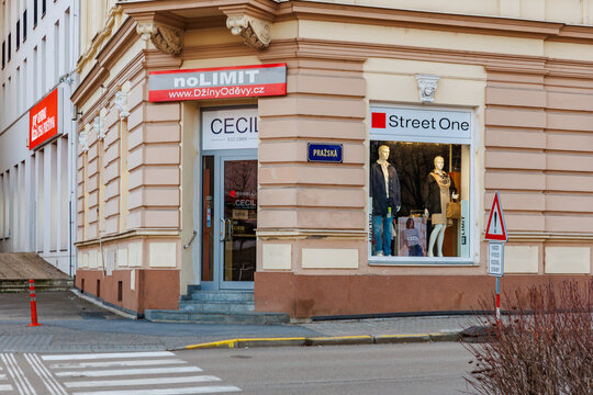 Clothing storefront on street corner with display windows and signage in urban setting. March 17, 2025, Benesov, Czech Republic