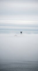 Solitary Vessel in a Misty Seascape A Serene Coastal Photograph