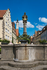 Fototapeta premium The Herrenbrunnen fountain in the old town of Rothenburg ob der Tauber in Middle Franconia