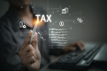 Person interacting with a futuristic digital interface displaying the word TAX and various financial icons