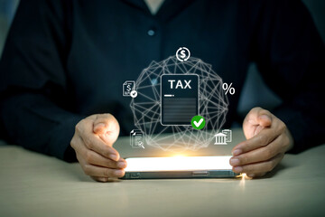A person holds a smartphone displaying a futuristic interface for online tax filing and financial...