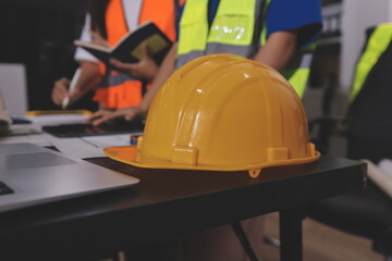 Closeup of team of industrial engineers meeting analyze machinery blueprints consult project on...