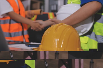 Closeup of team of industrial engineers meeting analyze machinery blueprints consult project on...