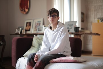 young man sitting on a sofa at home