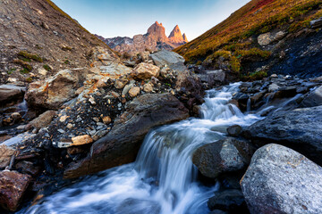 Scenic view of Aiguilles d Arves with iconic mountain peak and stream rapids flowing in French Alps