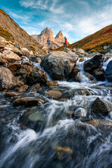 Scenic view of Aiguilles d Arves with iconic mountain peak and stream rapids flowing in French Alps
