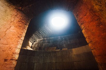 Inside traditional pottery kiln with pile of clay tile