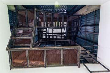Below inside steel staircase geometric design with wire mesh in tower