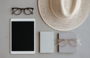 Stylish Workspace Flatlay with Tablet, Notebook, Glasses, and Straw Hat