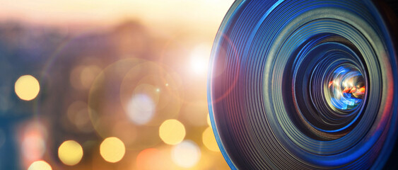 Сamera lens on the background of the city lights. Concept on the topic of news, information. Camera Lens background.