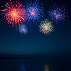 Colorful fireworks exploding in night sky over calm water with reflections, festive celebration background
