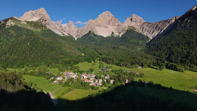 Aerial view of La Jarjatte village and forest in the Devoluy Massif. Limestone mountain peaks of Vercors Park, Drome, French Alps, France