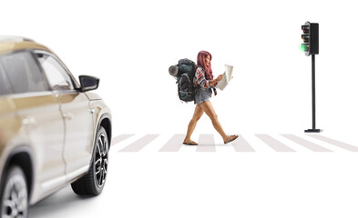 Female tourist with a backpack walking crossing a street and reading a map
