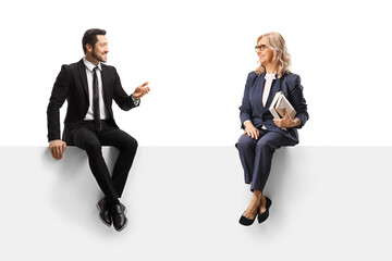 Businessman sitting on a panel and talking to a woman