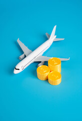 Airplane and a stack of coins. Flights and air traffic. Income and taxes. Saving on bonus programs....