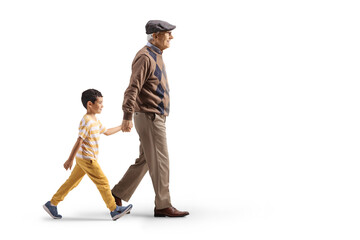 Grandfather and grandson walking and holding hands