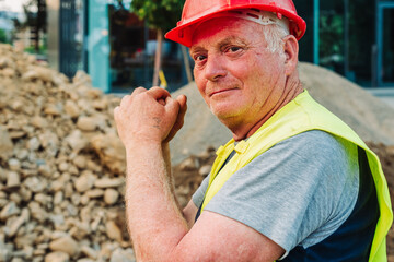 Construction workers repairing city infrastructure with heavy equipment and red polypropylene pipes. Urban utility maintenance, excavation, and roadwork in progress