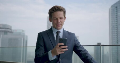 Businessman in Suit using Phone at Office Rooftop in City - Powered by Adobe