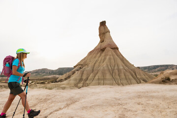Female trekker walking past Castildetierra in Bardenas Reales. Lifestyle. Hiking. Bardenas Reales.
