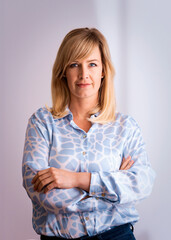 Blond haired woman standing against isolated background