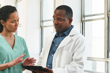 Doctor and Nurse Collaborating in a Bright Healthcare Facility for Patient Care